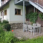 Ferienwohnung Außenbereich: Terrasse mit Garnitur und anliegendem Rasen